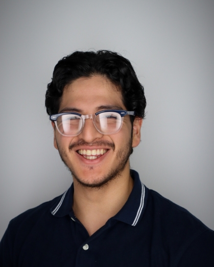 Head shot of male student with black, short hair wearing eyeglasses.